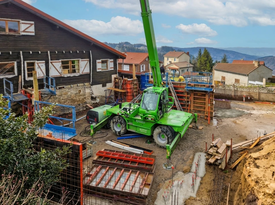 Chantier de construction urbain en extérieur avec ouvriers équipés de casques de sécurité travaillant sur une structure en béton armé